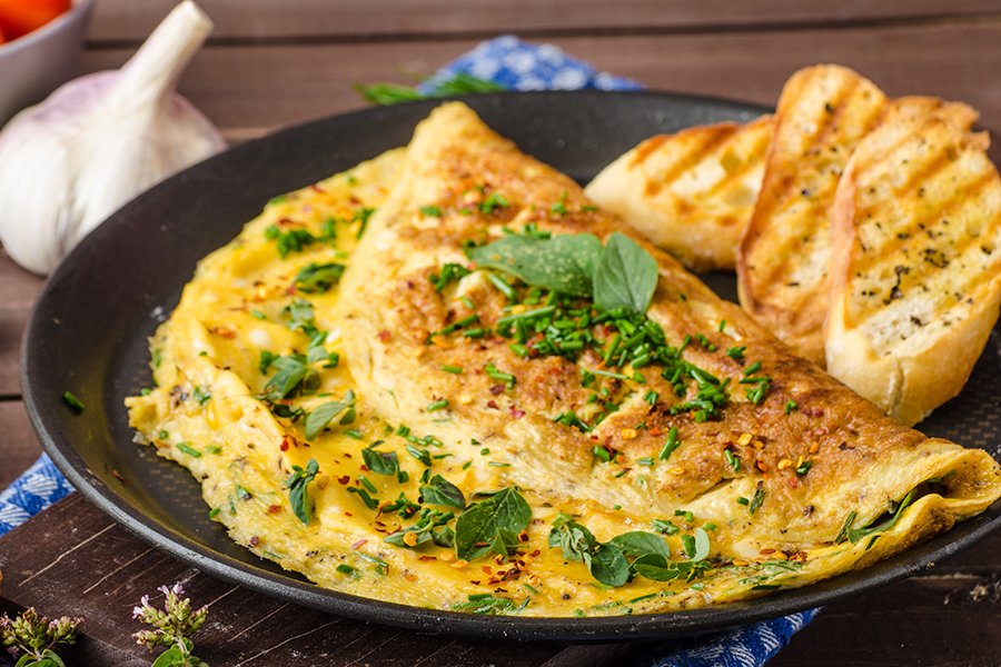 Herb omelette with chives and oregano sprinkled with chili flakes